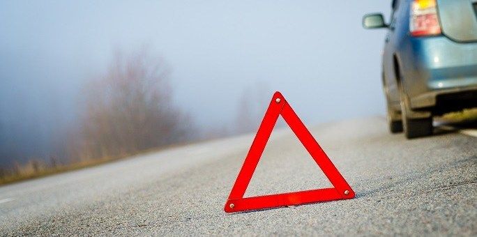 reflective-triangle-on-road-behind-car_istock_cropped